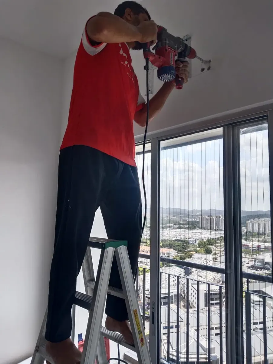 Aircond service technician working on an air conditioning unit in Petaling Jaya, KL & Selangor