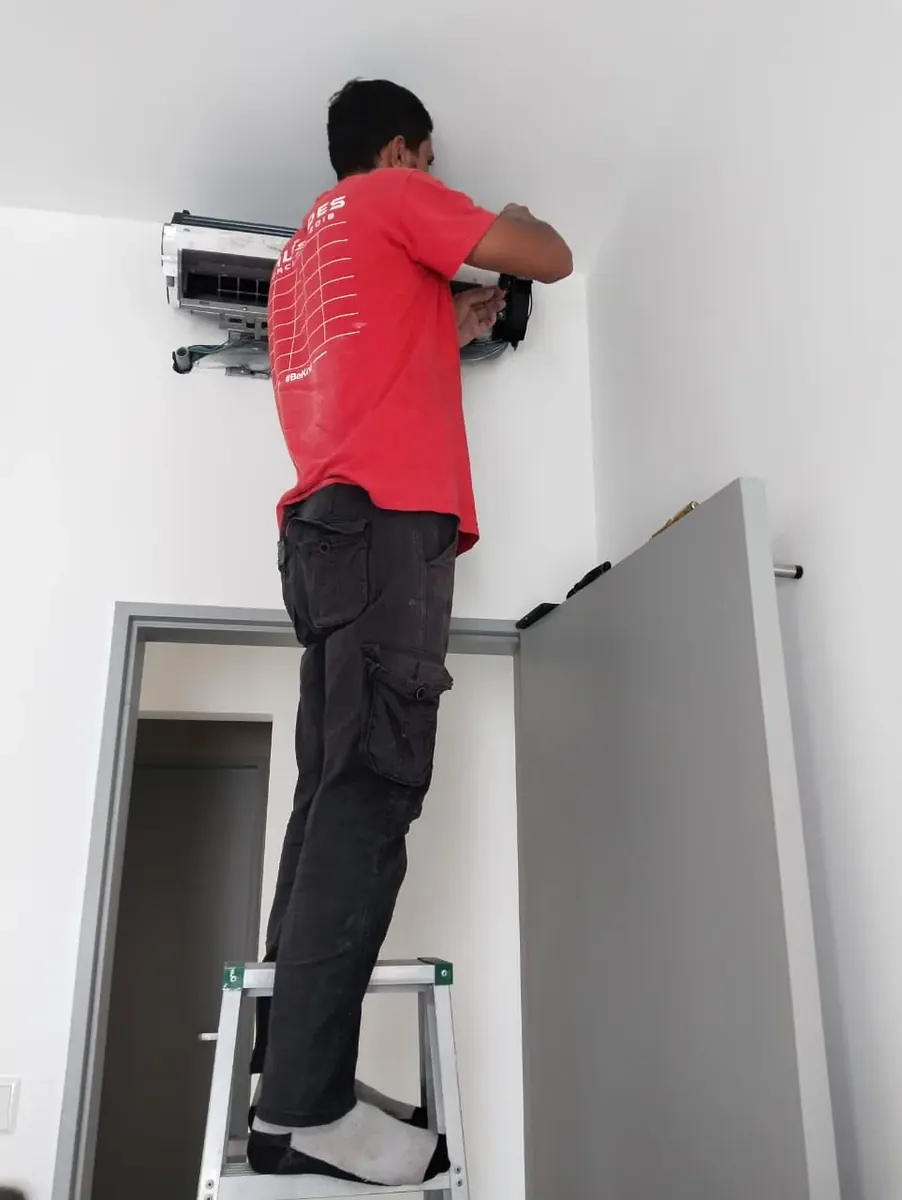 KL Renovator technician fixing a Daikin aircond water leak in Kuala Lumpur by clearing the drain path