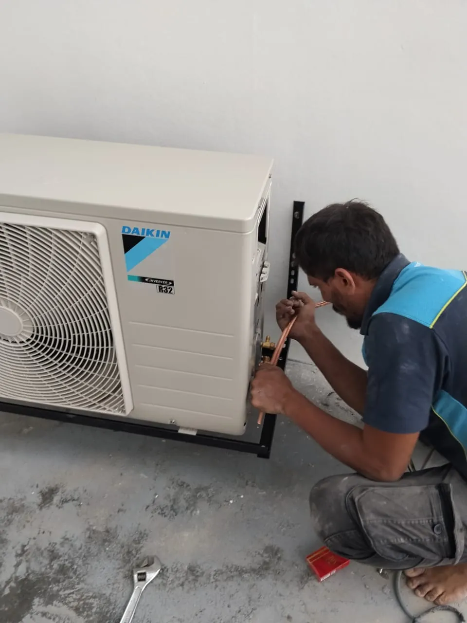 KL Renovator technician performing a new wall-mounted aircond installation on a Daikin unit in Rawang