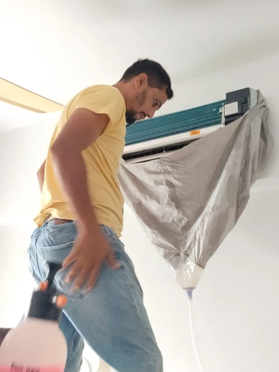 Ceiling cassette front panel lowered for servicing above a shoplot ceiling in Puchong